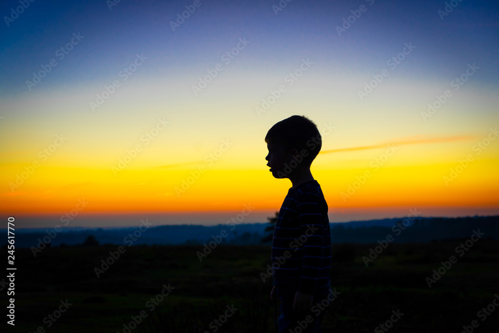 silhouette of a boy at sunset
