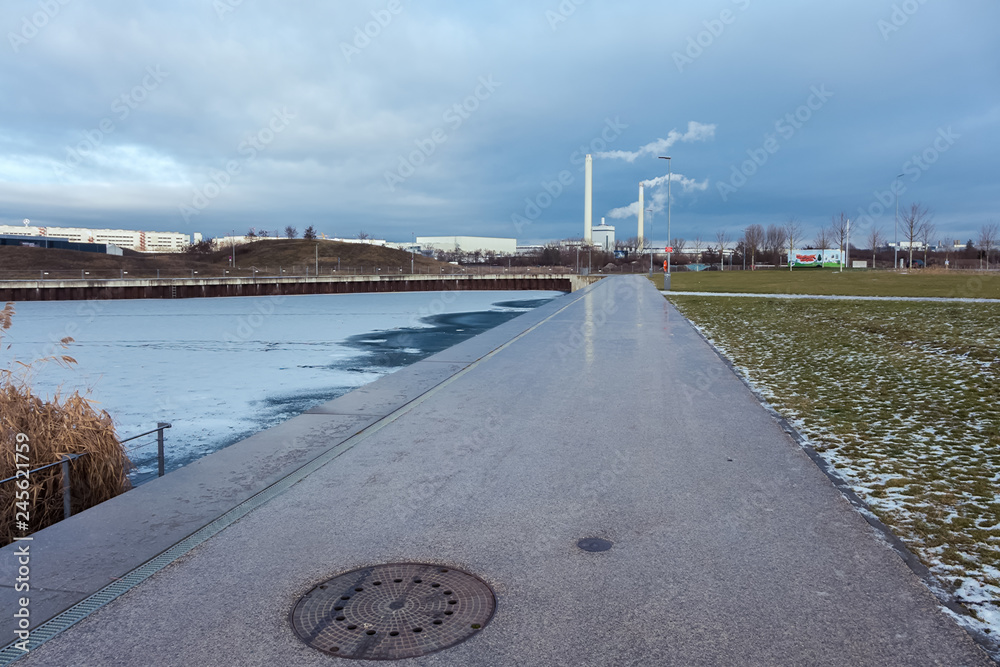 A park area with a frozen lake in a German city A park area with a frozen lake in a German city