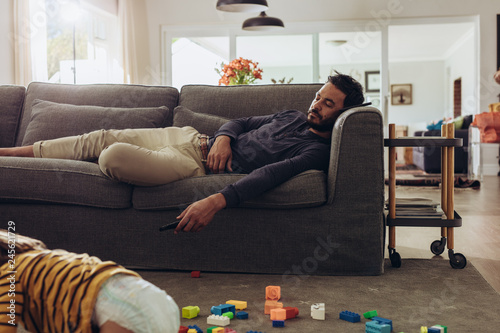 Man sleeping on couch at home