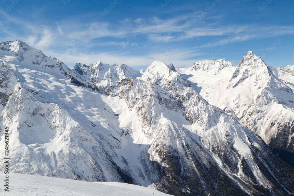 Ridge of the Caucasus Mountains near the town of Dombay, Russia on a sunny winter day Ridge of the Caucasus Mountains near the town of Dombay, Russia on a sunny winter day