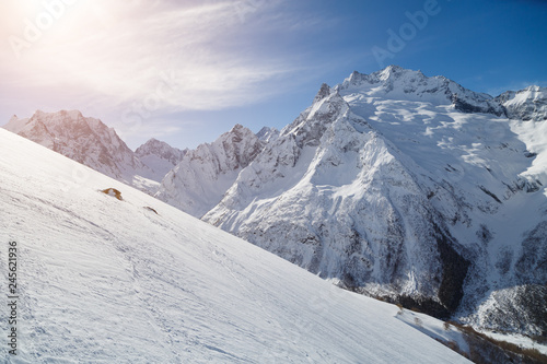 Smooth ski slopes of the Caucasus Mountains on a sunny winter day © ovbelov1972
