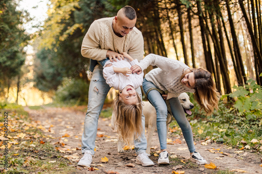Happy family is having fun walking in the park. Happy family is having fun walking in the park.