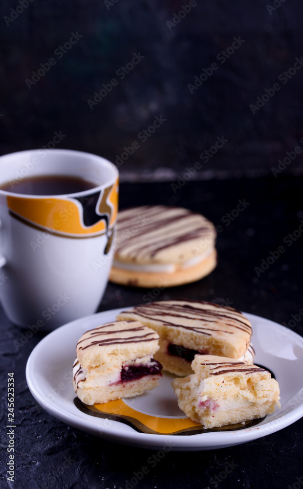 Delicious desserts on a black background. Cookies and marshmallows on the background. Fragrant dessert. Delicious desserts on a black background. Cookies and marshmallows on the background. Fragrant dessert.