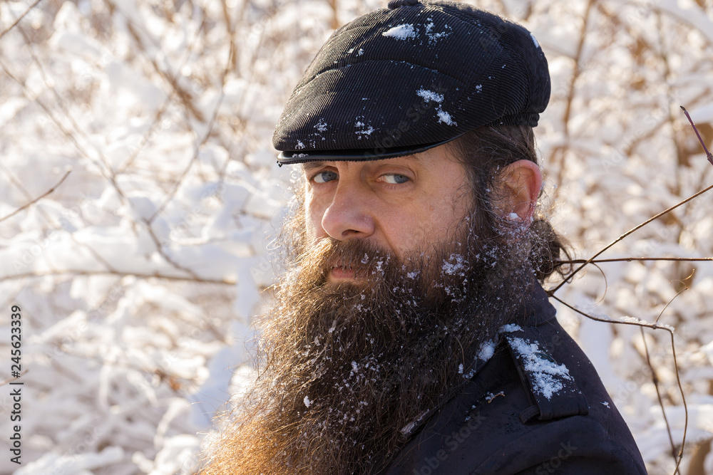 A man with a beard in the snow. A man with a beard in the snow.