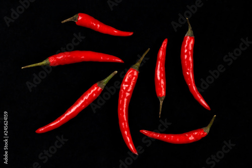 group of red chili peppers on black background