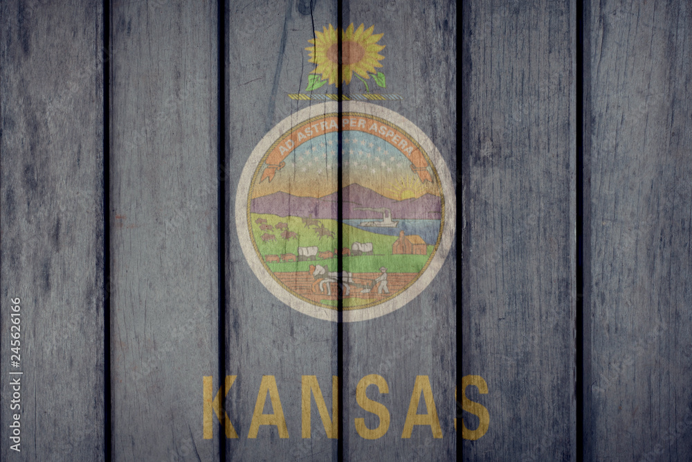 USA Politics News Concept: US State Kansas Flag Wooden Fence