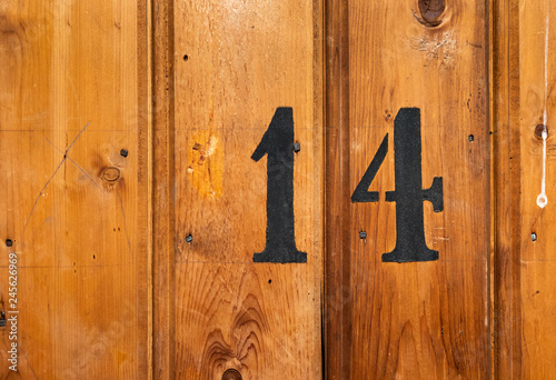 Photography number 14 on door of storage room for tenants in century-old apartment building