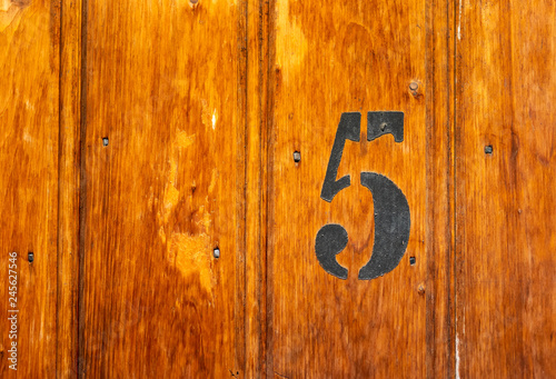 number 5 on door of storage room for tenants in century-old apartment building in stockholm