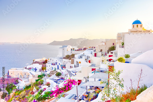 Travel Destinations. People Preparing for Sunset at Caldera Volcanic Slope of Oia Village in Santorini Island in Greece.