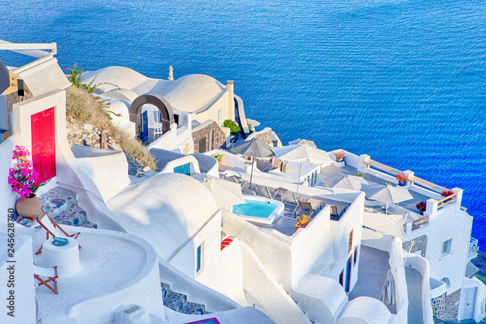 Obraz premium Famous Destinations. Breathtaking View of Classic White Roofed Houses and Pastel-Blue Colors of Oia Village on Santorini Island in Greece