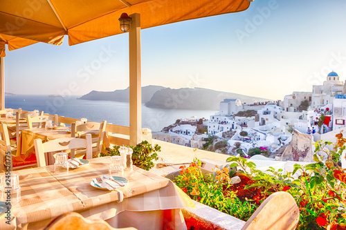 Obraz na plátně Open Air Cosy Restaurant in Beautiful Oia Village on Santorini Island in Greece Straight Before the Sunset