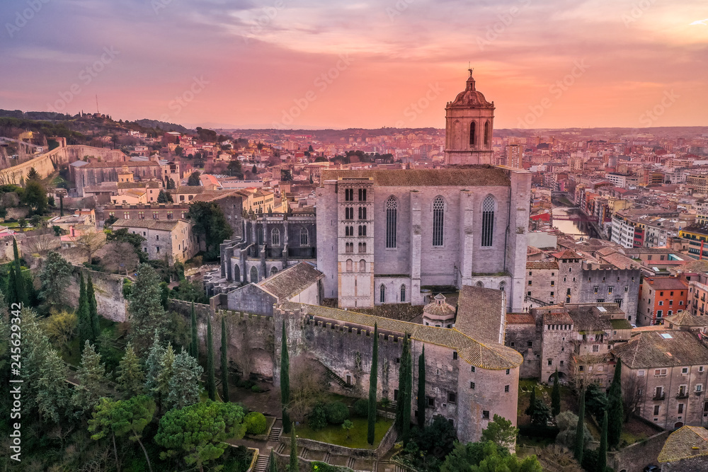 Aerial panorama view of medieval Girona with Gothic St Mary Roman Catholic cathedral, city walls and colorful houses at sunset in Girona Catalonia Spain
