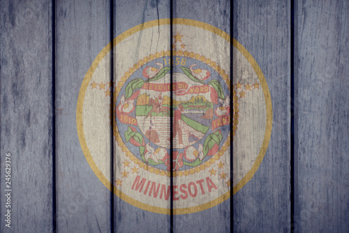 USA Politics News Concept: US State Minnesota Flag Wooden Fence