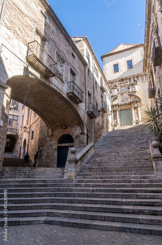 View of medieval buildings  tower and street in Girona Catalonia  Spain with blue sky  popular tourist town one hour from Barcelona