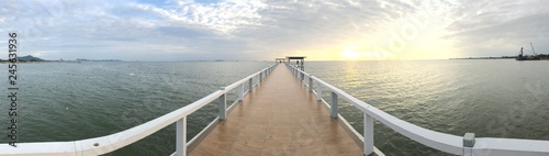 Bridge sea beyond frointier sunset