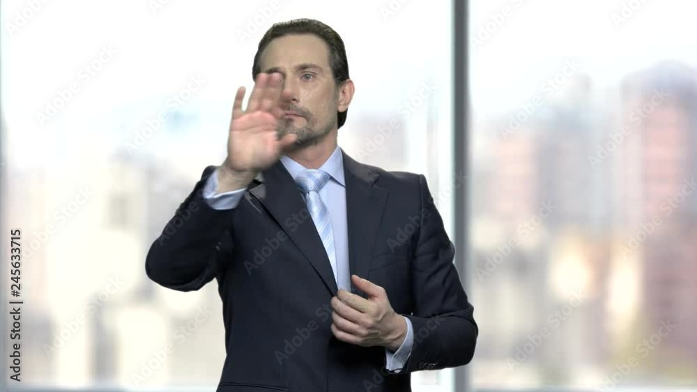 Confident businessman working on virtual screen. Mature manager using touch screen display. People, business and future technology concept. Confident businessman working on virtual screen. Mature manager using touch screen display. People, business and future technology concept.