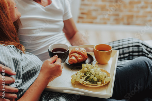 Man and woman havin breakfast together in bed photo