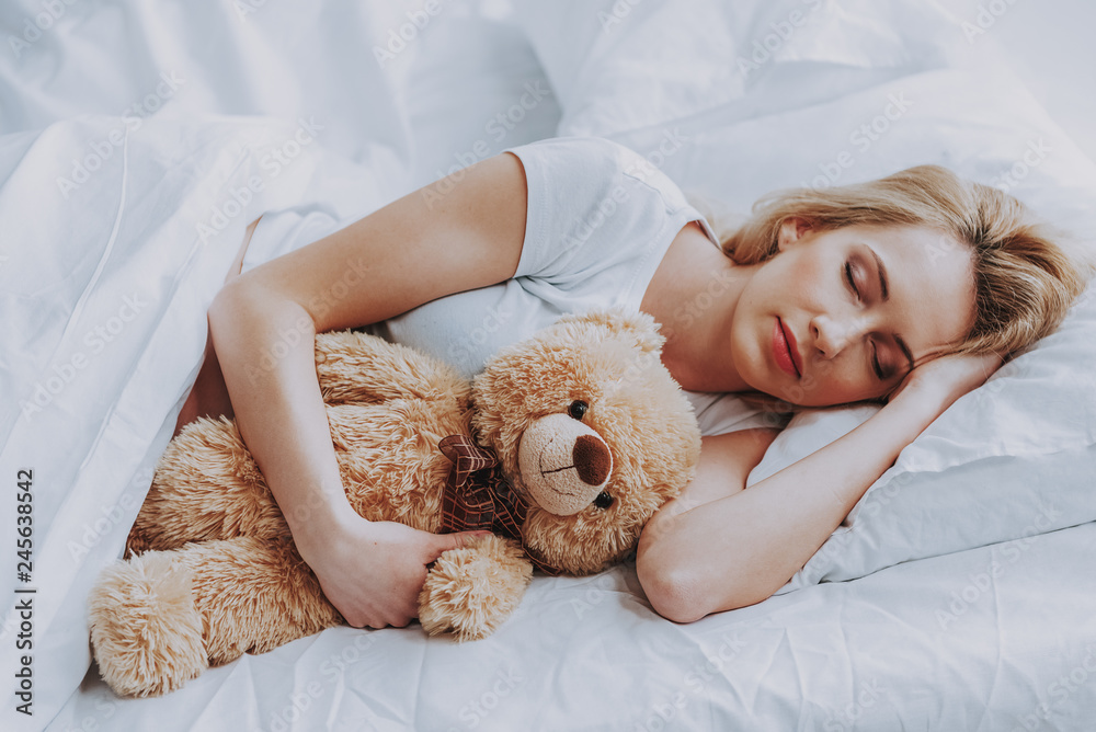 Young expectant woman sleeping in cozy bedroom