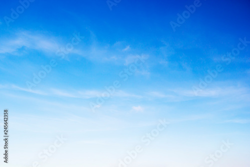 Fototapeta Naklejka Na Ścianę i Meble -  Fluffy blue sky background and white clouds soft focus, and copy space