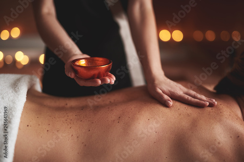 Close up of massage bowl with essential oil photo
