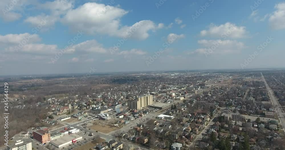 Ascending Over Small Town In Early Spring Aerial View With Traffic On Roads Ascending Over Small Town In Early Spring Aerial View With Traffic On Roads
