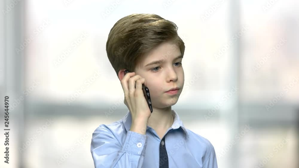Close up little boy talking on phone. Handsome child using smartphone on blurred background. Children, modern technology, communication. Close up little boy talking on phone. Handsome child using smartphone on blurred background. Children, modern technology, communication.