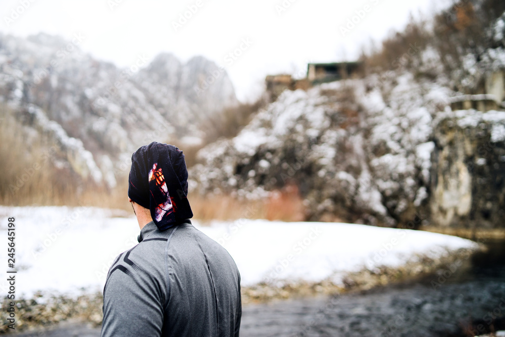 Ultra trail Marathon Runner Standing By The River In Winter