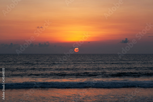 red ocean sunset on bali island photo