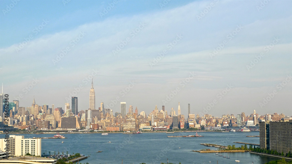 A view of the buildings and skyscrapers of New York City's midtown Manhattan as seen across the Hudson river from New Jersey.