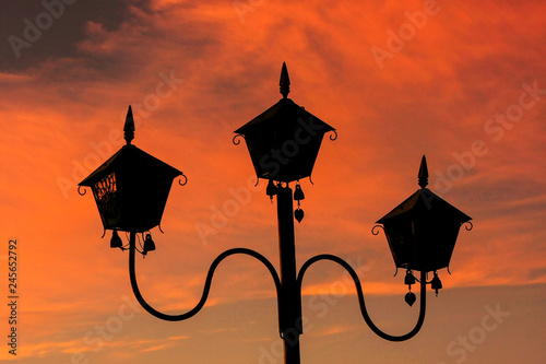 Silhouette of a lamp post at sunset at Sutaungpyei Pagoda on the top of Mandalay Hill, Mandalay, Myanmar photo