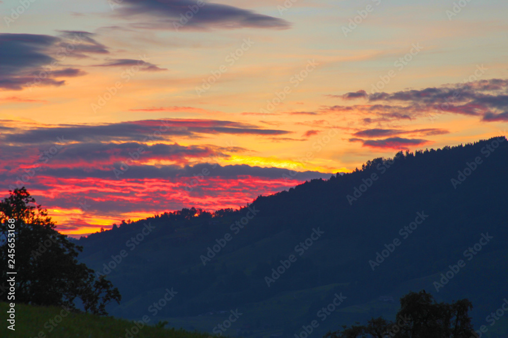 The most beautiful sunset in Switzerland, the sky is bright with bright, orange, yellow bright colors, late summer evening.