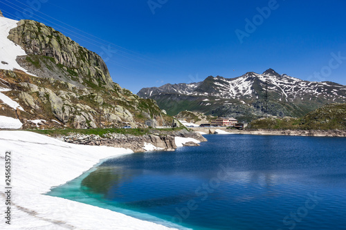 Snow melting in the waters of Totensee lake at Grimsel Pass (2.164 m), Switzerland