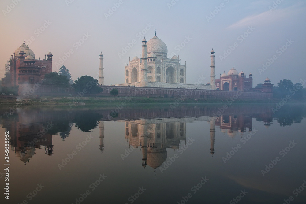 View of Taj Mahal with early morning fog reflected in Yamuna River, Agra, Uttar Pradesh, India