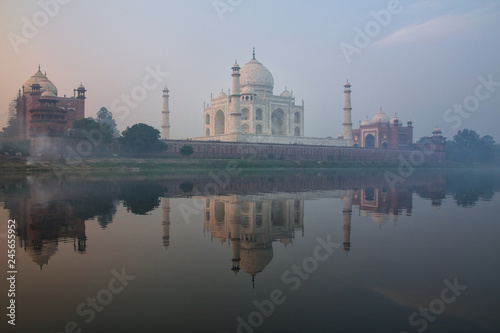 View of Taj Mahal with early morning fog reflected in Yamuna River, Agra, Uttar Pradesh, India © donyanedomam