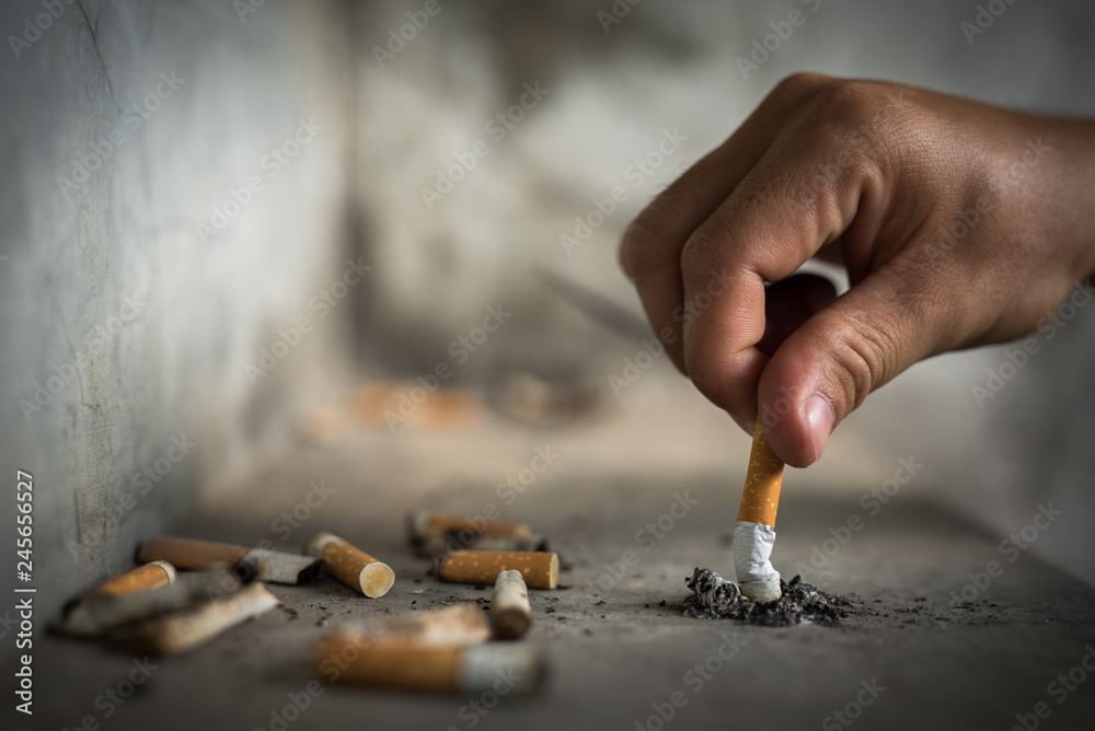 Photography Hand putting out a cigarette,cigarette butt.