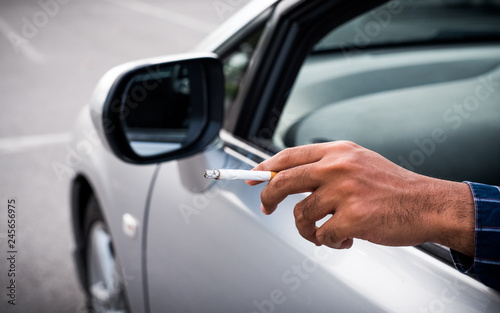 Close up male hand  smoking in car © Nopphon