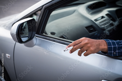 Close up male hand smoking in car
