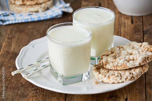 Two glasses of fresh yogurt on a wooden table
