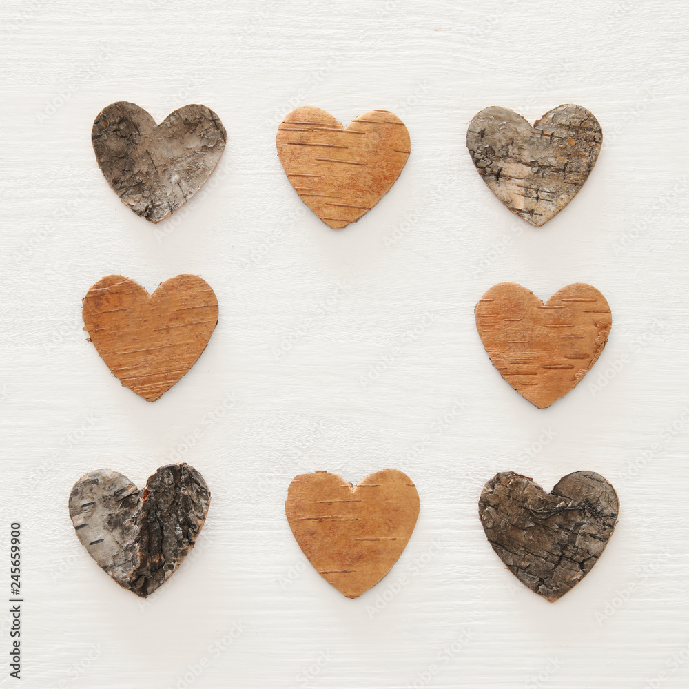 Valentine's day concept. hearts cutted from tree trunk over wooden white background. Valentine's day concept. hearts cutted from tree trunk over wooden white background.
