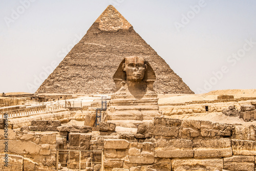 Egyptian Great Sphinx full body portrait head with pyramids of Giza background Egypt empty with nobody. copy space