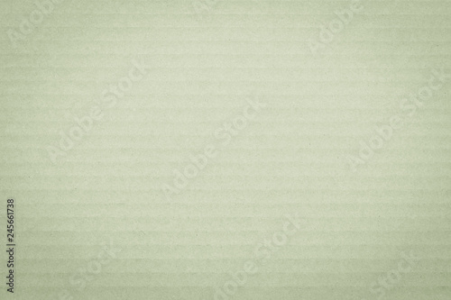 Recycled cardboard textured grunge detailed backdrop in yellow green pastel color