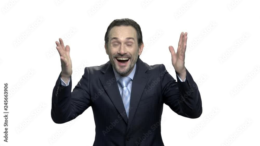 Excited mature businessman with raised hands in the air. Expressive middle-aged man in suit celebrating victory over white background. Lucky winner concept. Excited mature businessman with raised hands in the air. Expressive middle-aged man in suit celebrating victory over white background. Lucky winner concept.