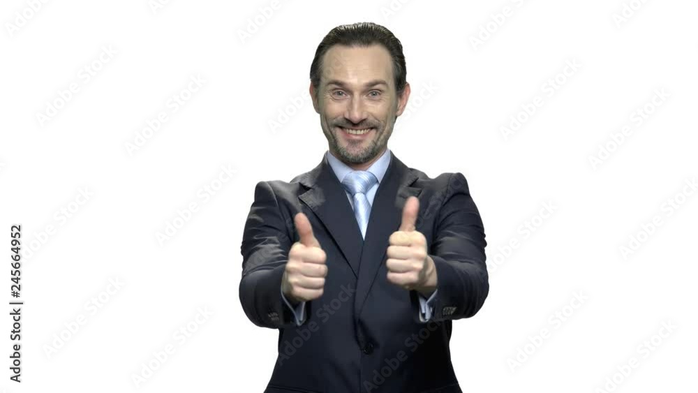 Cheerful businessman gesturing thumbs up. Handsome mature manager or employee giving thumbs up with both hands. People, business and gestures concept. Cheerful businessman gesturing thumbs up. Handsome mature manager or employee giving thumbs up with both hands. People, business and gestures concept.