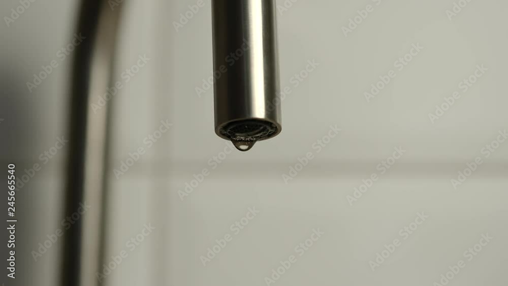 Dripping faucet on a white background - Slow motion Dripping faucet on a white background - Slow motion