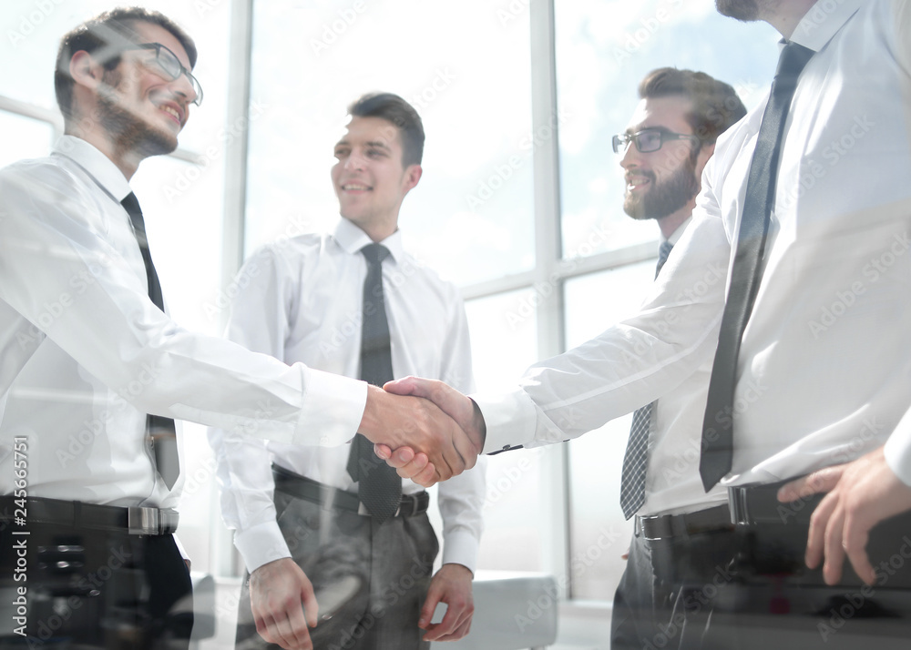 business colleagues shaking hands in the office business colleagues shaking hands in the office