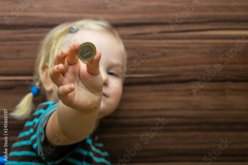 child shows one euro coin