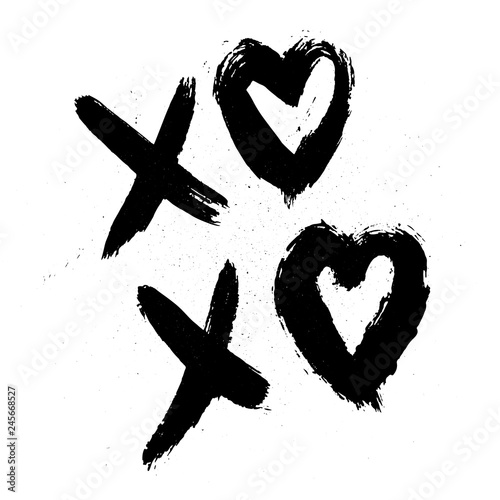 XOXO hand written phrase with hearts isolated on white background with ink spray. Hugs and kisses sign. Grunge brush lettering XO. Easy to edit template for Valentine’s day greeting card, poster, etc. photo