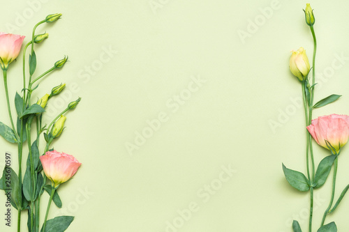 Pink eustoma flowers border. Floral design concept. Copy space on palegreen background. Flat lay.