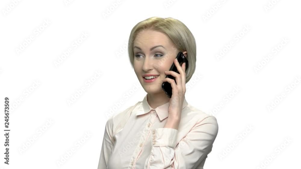 Cheerful woman in formal wear talking on phone. Happy emotional business lady having phone conversation over white background. Cheerful woman in formal wear talking on phone. Happy emotional business lady having phone conversation over white background.