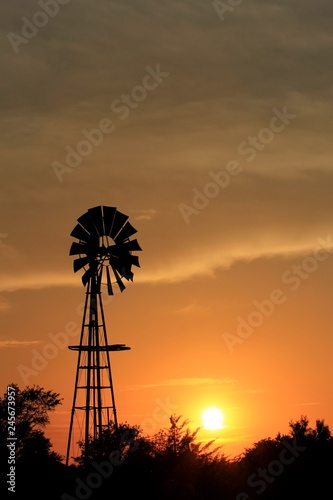 windmill at sunset with a silhouette